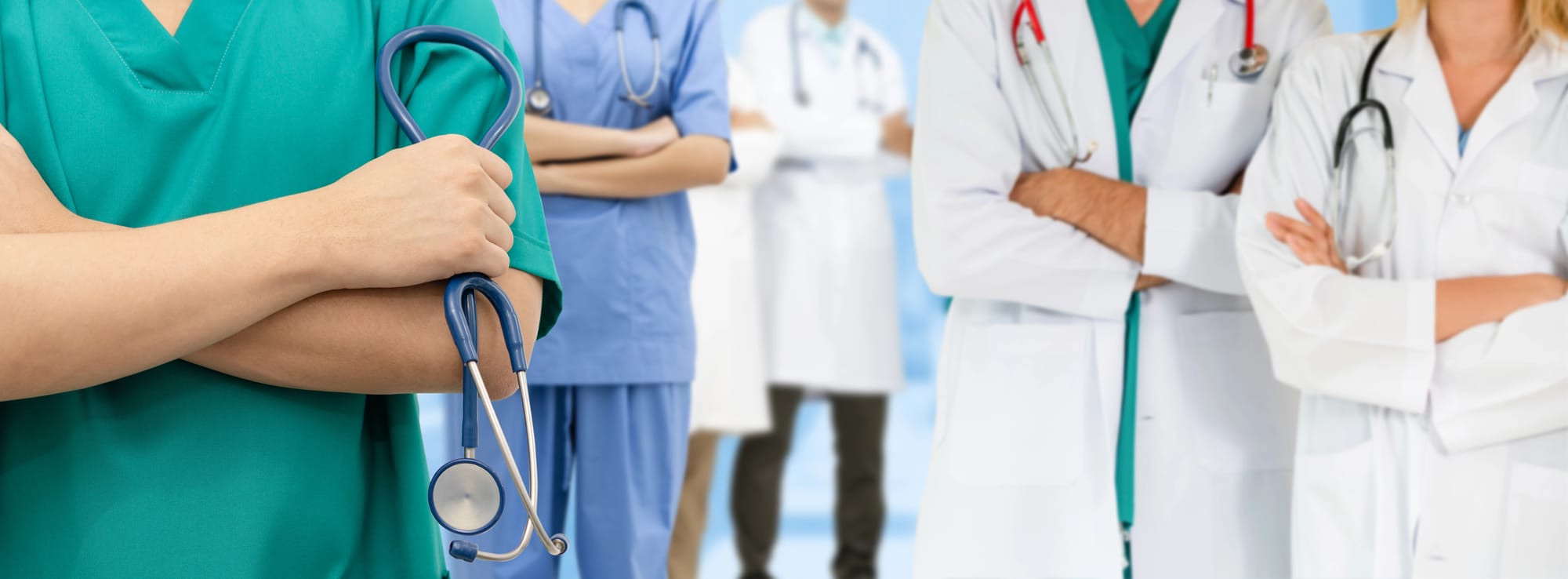 Group of doctors standing side by side without showing faces.